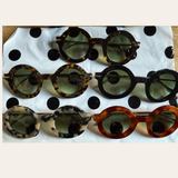 Lamusunglasses round frame sunglasses in tortoiseshell, black, and marbled acetate with gradient lenses.